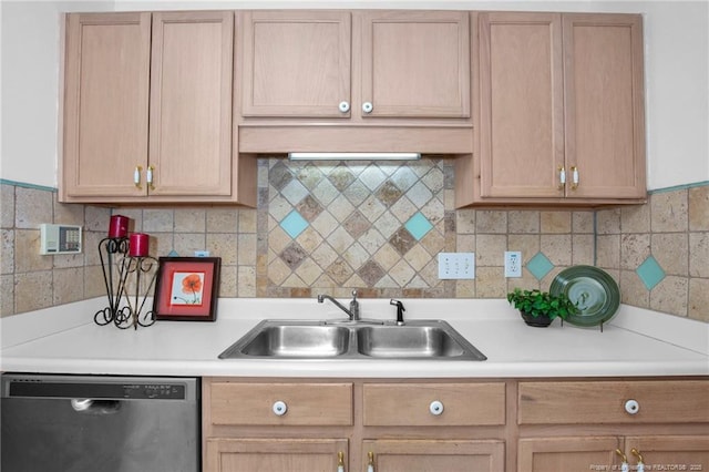 kitchen with dishwasher, a sink, light countertops, and backsplash