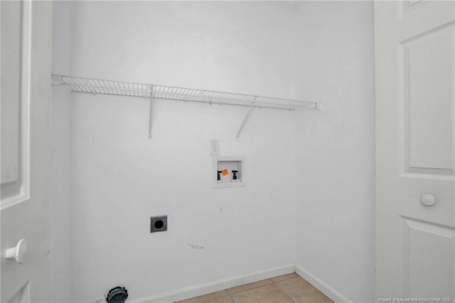 washroom featuring hookup for an electric dryer, hookup for a washing machine, baseboards, and light tile patterned flooring