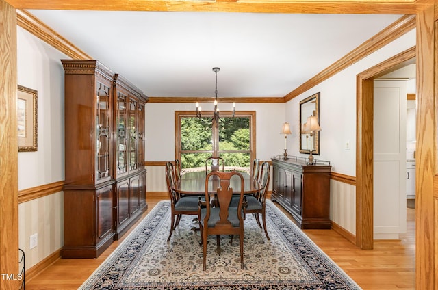 108 Hanover Pl, Chapel Hill, NC 27516 - dining room with light wood-type flooring, a chandelier, baseboards, and crown molding