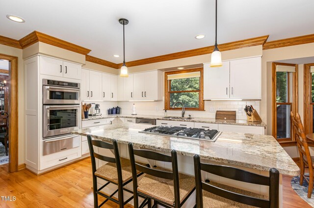 108 Hanover Pl, Chapel Hill, NC 27516 - kitchen featuring a warming drawer, a sink, stainless steel appliances, ornamental molding, and tasteful backsplash
