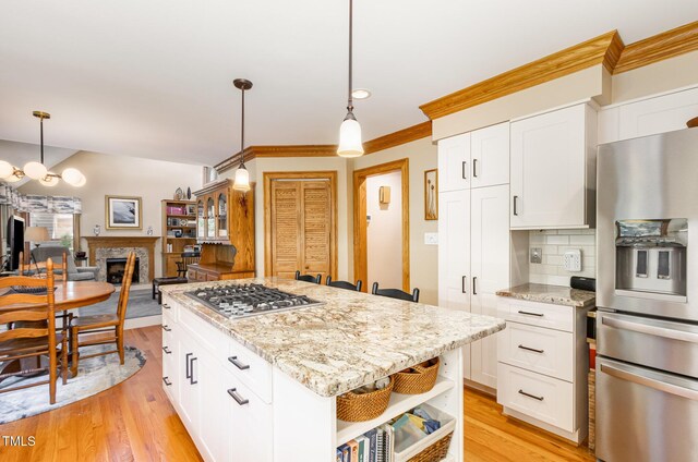 108 Hanover Pl, Chapel Hill, NC 27516 - kitchen with stainless steel appliances, open shelves, ornamental molding, backsplash, and white cabinetry