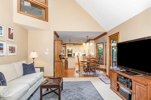 108 Hanover Pl, Chapel Hill, NC 27516 - living room with baseboards, high vaulted ceiling, crown molding, wood finished floors, and a chandelier