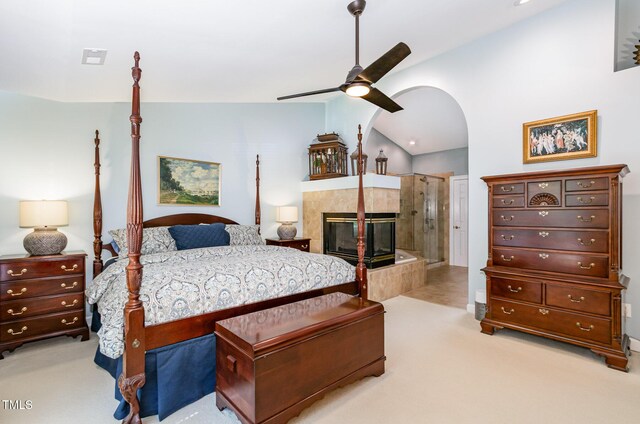 108 Hanover Pl, Chapel Hill, NC 27516 - bedroom with lofted ceiling, light colored carpet, arched walkways, a fireplace, and ceiling fan