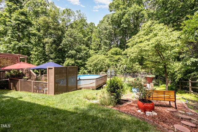 108 Hanover Pl, Chapel Hill, NC 27516 - view of yard featuring an outdoor pool, a wooden deck, and a view of trees