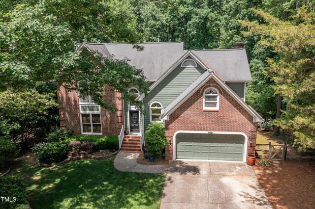 108 Hanover Pl, Chapel Hill, NC 27516 - view of front of house with driveway, a chimney, brick siding, a garage, and a gate