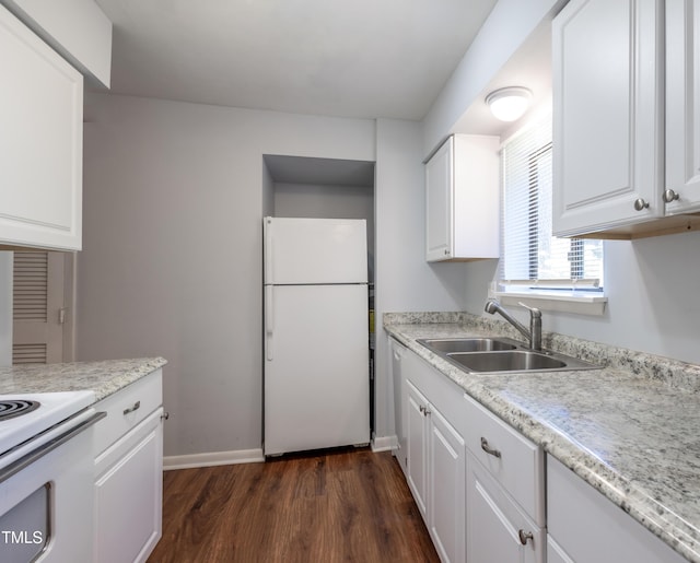 kitchen featuring freestanding refrigerator, a sink, dark wood-style flooring, light countertops, and white cabinets