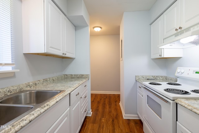 kitchen with white electric stove, under cabinet range hood, dark wood finished floors, white cabinetry, and baseboards