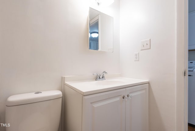 half bathroom with vanity and toilet