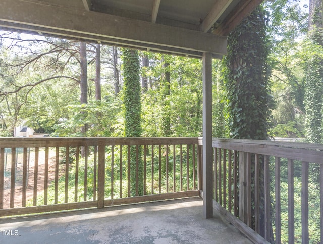 wooden deck featuring a view of trees
