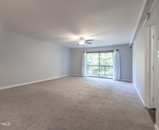 spare room with ceiling fan, carpet flooring, and baseboards