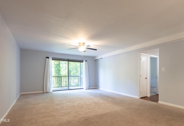 unfurnished room featuring carpet flooring, ceiling fan, and baseboards