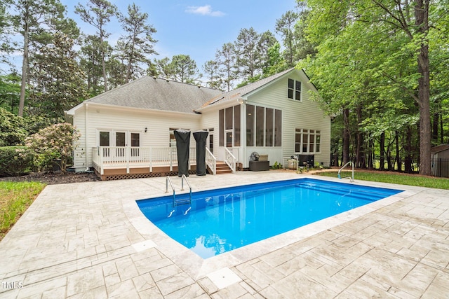 12301 Hardee Rd, Raleigh, NC 27614 - rear view of property with a deck, a sunroom, an outdoor pool, and a shingled roof