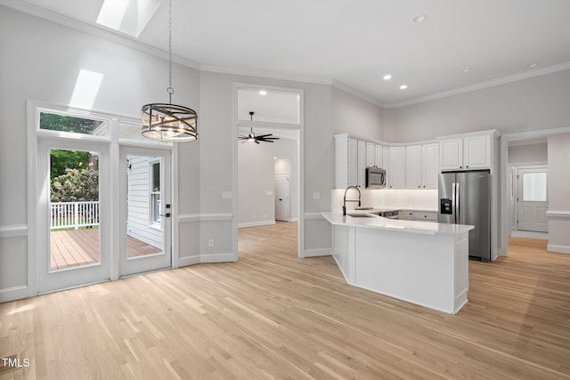 12301 Hardee Rd, Raleigh, NC 27614 - kitchen featuring stainless steel appliances, ornamental molding, a chandelier, light countertops, and white cabinets