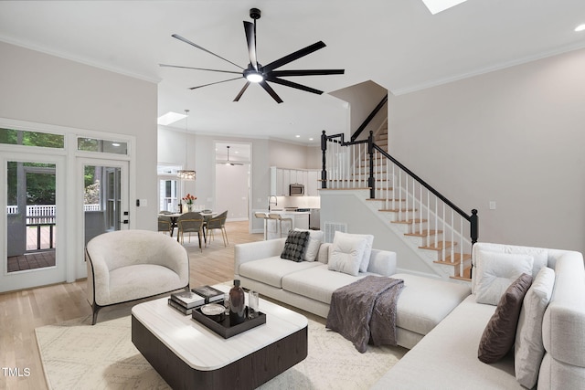 12301 Hardee Rd, Raleigh, NC 27614 - living room with a ceiling fan, crown molding, light wood-type flooring, stairway, and recessed lighting