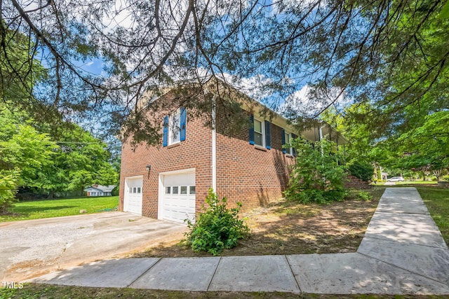 4407 Bromley Dr, Greensboro, NC 27406 - view of side of property with brick siding, driveway, and an attached garage