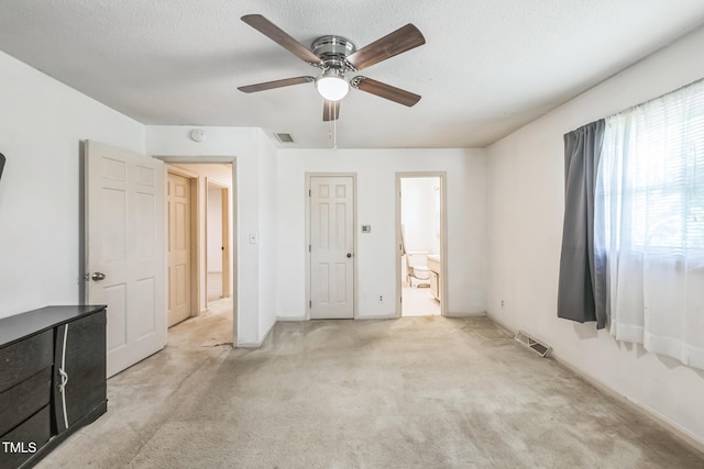 4407 Bromley Dr, Greensboro, NC 27406 - unfurnished bedroom featuring light colored carpet, connected bathroom, ceiling fan, and baseboards