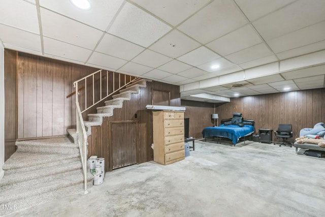 4407 Bromley Dr, Greensboro, NC 27406 - finished below grade area featuring wood walls, a drop ceiling, and stairs