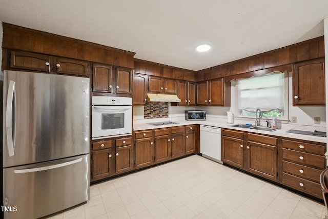 4407 Bromley Dr, Greensboro, NC 27406 - kitchen with stainless steel appliances, a sink, light countertops, and under cabinet range hood