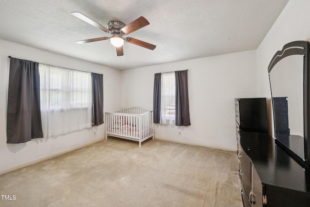 4407 Bromley Dr, Greensboro, NC 27406 - unfurnished bedroom with carpet flooring, a textured ceiling, and a ceiling fan