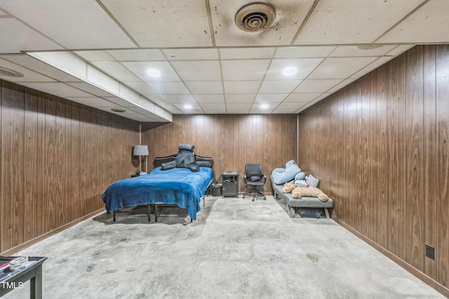 4407 Bromley Dr, Greensboro, NC 27406 - bedroom with wooden walls, unfinished concrete flooring, baseboards, and a paneled ceiling