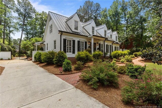 2190 Keith Hills Rd, Lillington, NC 27546 - view of front facade featuring concrete driveway, metal roof, and a standing seam roof