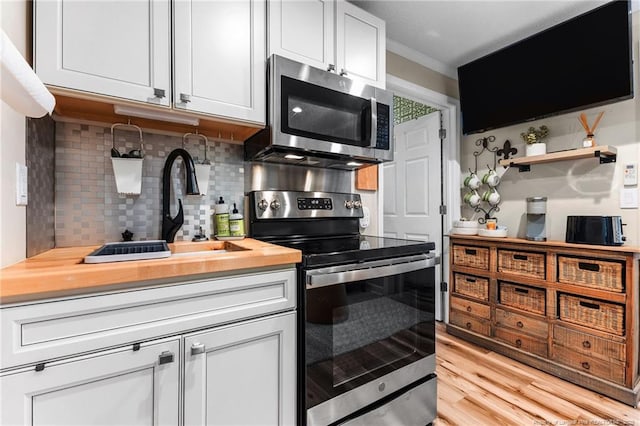 2190 Keith Hills Rd, Lillington, NC 27546 - kitchen featuring stainless steel appliances, butcher block countertops, backsplash, light wood-style floors, and a sink