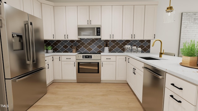 4091 Elk Creek Ln Unit 9, Raleigh, NC 27612 - kitchen with stainless steel appliances, a sink, light wood finished floors, and backsplash