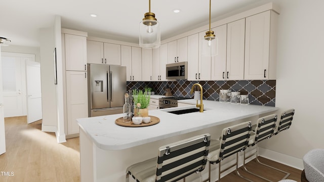 4091 Elk Creek Ln Unit 9, Raleigh, NC 27612 - kitchen with stainless steel appliances, a peninsula, tasteful backsplash, a kitchen bar, and light wood finished floors