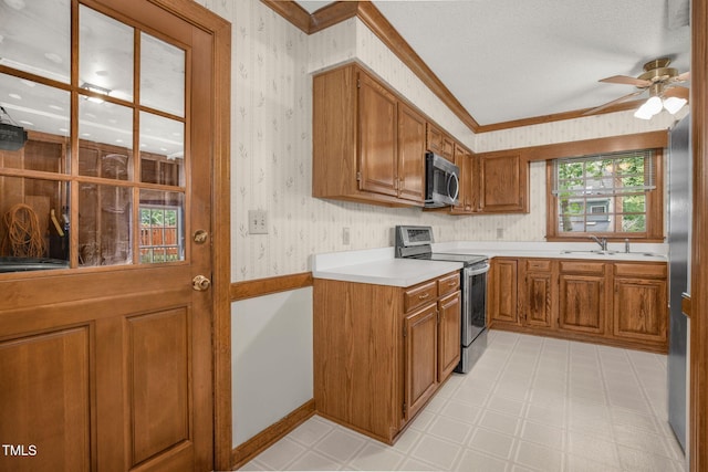 1113 Smokewood Dr, Apex, NC 27502 - kitchen with stainless steel appliances, brown cabinets, a sink, a ceiling fan, and wallpapered walls