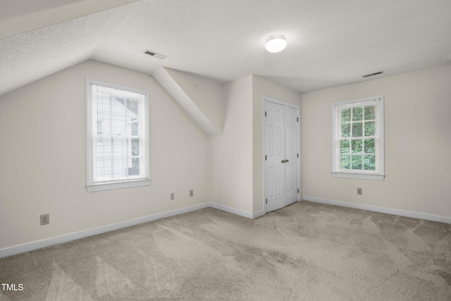 1113 Smokewood Dr, Apex, NC 27502 - bonus room with a textured ceiling, carpet, vaulted ceiling, and baseboards