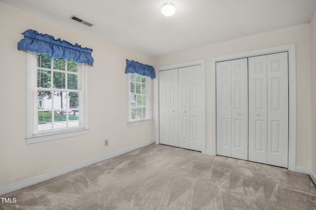 1113 Smokewood Dr, Apex, NC 27502 - unfurnished bedroom with carpet, two closets, and baseboards