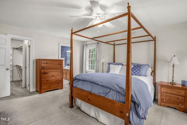 1113 Smokewood Dr, Apex, NC 27502 - bedroom featuring light carpet, a walk in closet, ensuite bathroom, ceiling fan, and a closet
