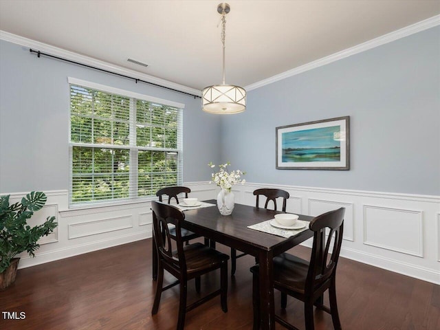 136 Shadow Hawk Dr, Durham, NC 27713 - dining space featuring crown molding, dark wood-type flooring, a wainscoted wall, and a decorative wall