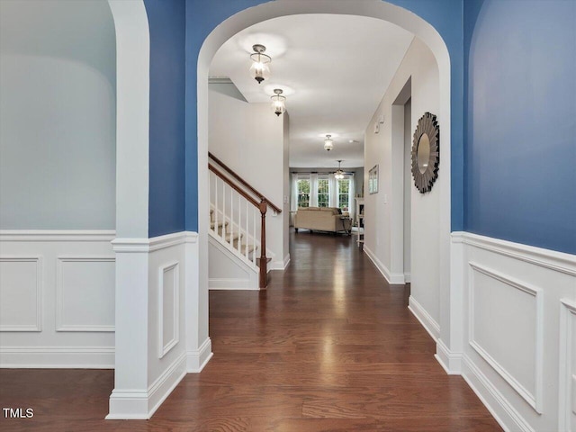 136 Shadow Hawk Dr, Durham, NC 27713 - entrance foyer with a decorative wall, stairs, a wainscoted wall, wood finished floors, and arched walkways
