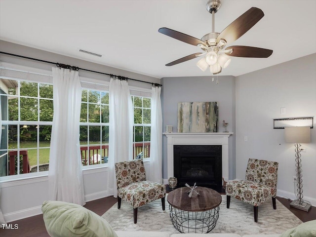 136 Shadow Hawk Dr, Durham, NC 27713 - living area featuring baseboards, wood finished floors, a glass covered fireplace, and ceiling fan