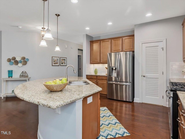 136 Shadow Hawk Dr, Durham, NC 27713 - kitchen featuring appliances with stainless steel finishes, a sink, brown cabinets, decorative backsplash, and recessed lighting