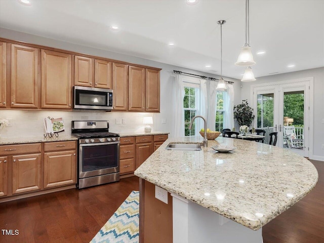 136 Shadow Hawk Dr, Durham, NC 27713 - kitchen featuring appliances with stainless steel finishes, a sink, light stone countertops, dark wood finished floors, and recessed lighting