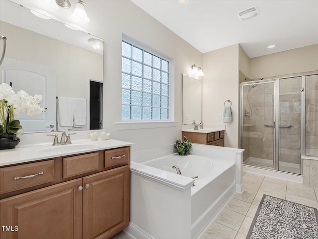 136 Shadow Hawk Dr, Durham, NC 27713 - full bath featuring a shower stall, a bath, two vanities, and tile patterned flooring