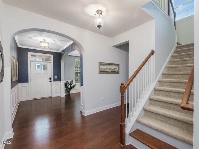 136 Shadow Hawk Dr, Durham, NC 27713 - foyer entrance with stairs, wood finished floors, arched walkways, ornamental molding, and a wainscoted wall