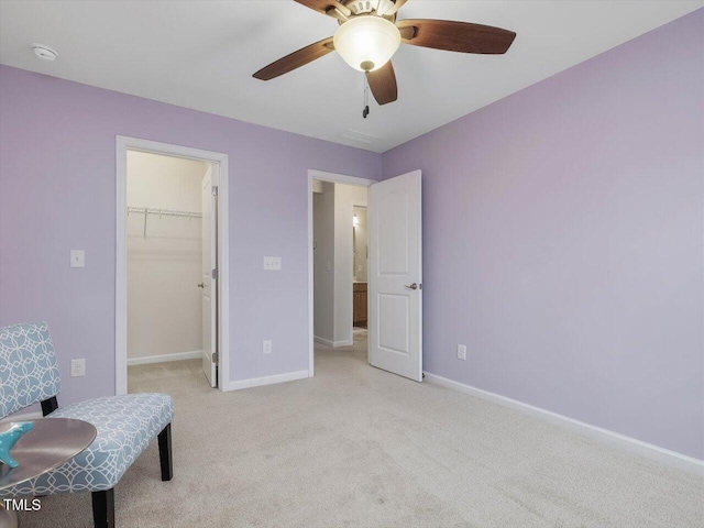 136 Shadow Hawk Dr, Durham, NC 27713 - bedroom with light colored carpet, baseboards, a walk in closet, a ceiling fan, and a closet
