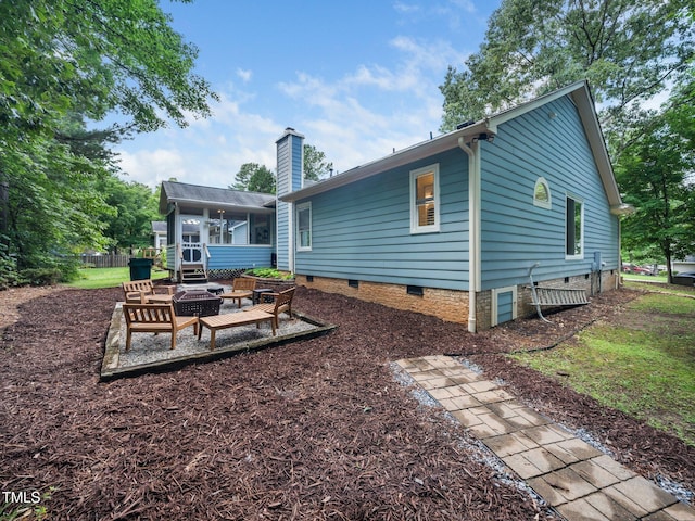 3400 Appling Way, Durham, NC 27703 - rear view of house featuring crawl space, a sunroom, a fire pit, and a chimney
