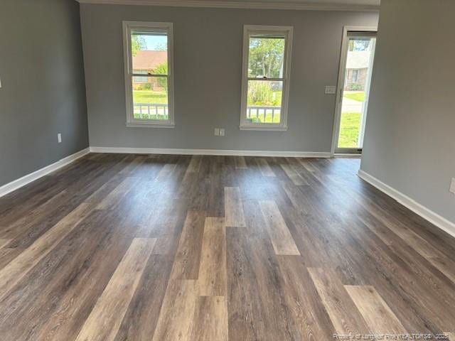 983 Eastment Dr, Fayetteville, NC 28314 - empty room featuring dark wood-style floors, ornamental molding, and baseboards