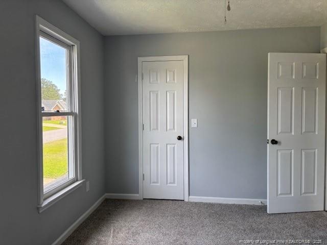 983 Eastment Dr, Fayetteville, NC 28314 - unfurnished bedroom featuring carpet and baseboards