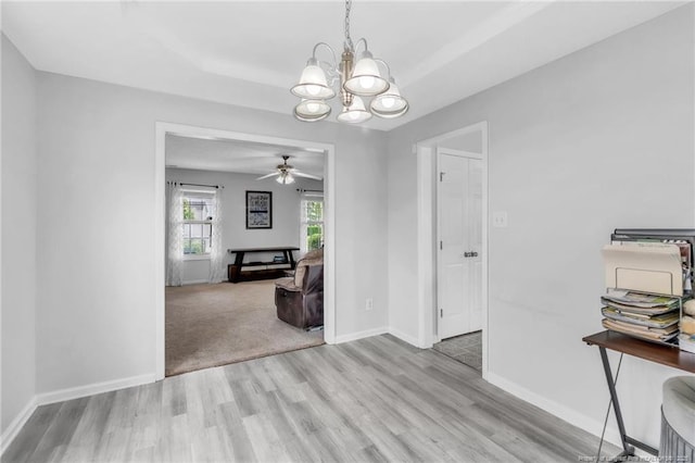 5028 Windflower Dr, Fayetteville, NC 28314 - dining area with wood finished floors, a chandelier, ceiling fan, and baseboards
