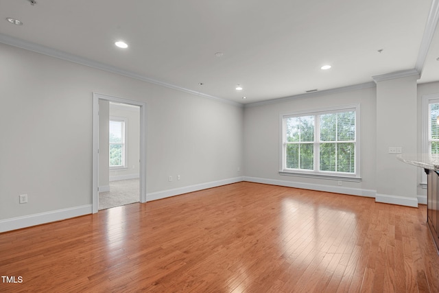 710 Independence Pl Unit 301, Raleigh, NC 27603 - unfurnished room with healthy amount of natural light, light wood-type flooring, baseboards, ornamental molding, and recessed lighting