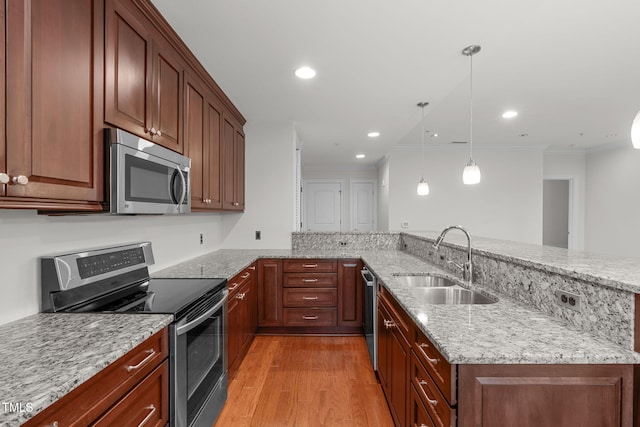 710 Independence Pl Unit 301, Raleigh, NC 27603 - kitchen with stainless steel appliances, a sink, light wood-style floors, crown molding, and light stone countertops