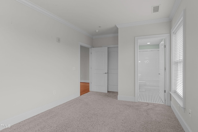 710 Independence Pl Unit 301, Raleigh, NC 27603 - unfurnished bedroom featuring carpet, crown molding, ensuite bathroom, and baseboards