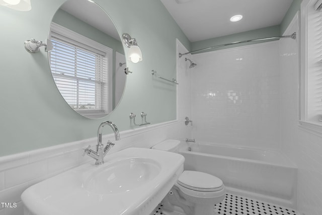 710 Independence Pl Unit 301, Raleigh, NC 27603 - bathroom with toilet, bathtub / shower combination, wainscoting, tile walls, and tile patterned flooring