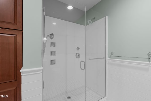 710 Independence Pl Unit 301, Raleigh, NC 27603 - bathroom featuring a shower stall, a wainscoted wall, tile walls, and recessed lighting
