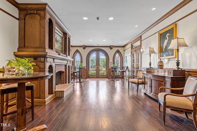 710 Independence Pl Unit 301, Raleigh, NC 27603 - sitting room featuring dark wood-style flooring, french doors, crown molding, a fireplace, and recessed lighting